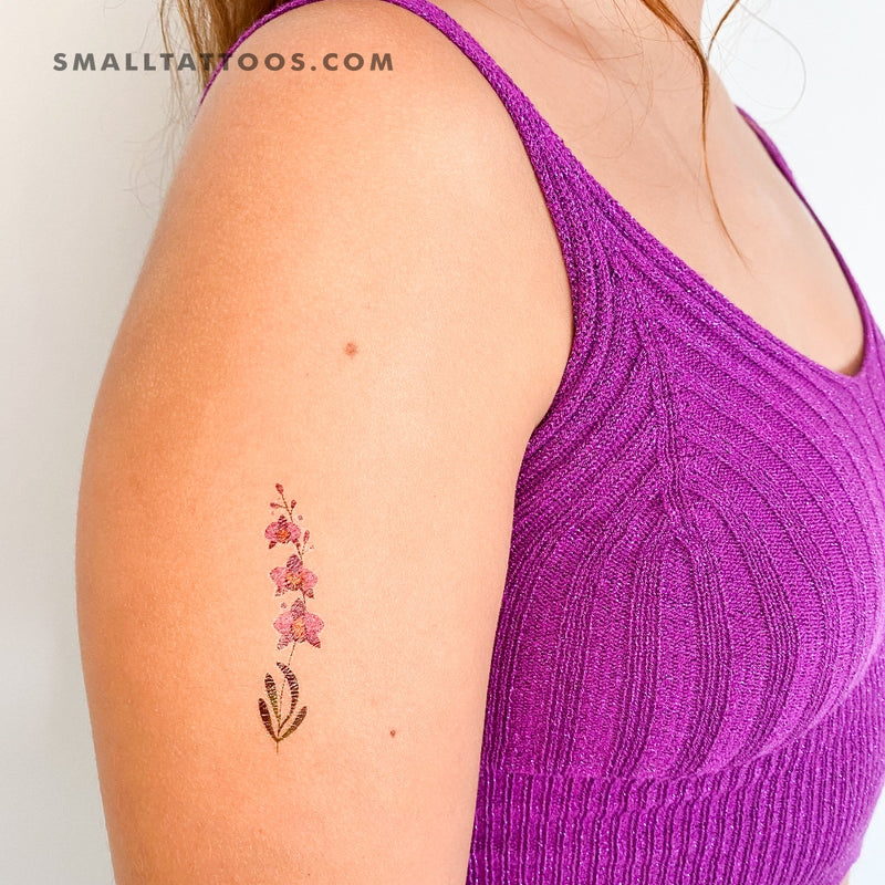 simple tattoo of an orchid sprouting from the earth - Arthub.ai