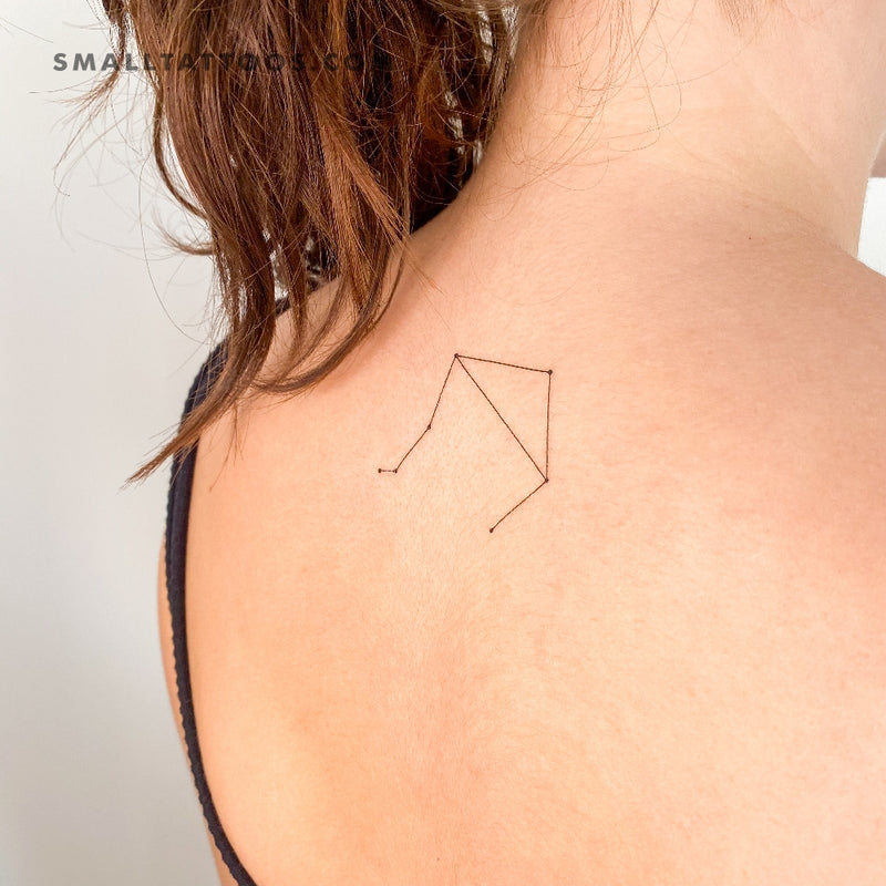 Minimalist Libra symbol and moon tattoo on the wrist.