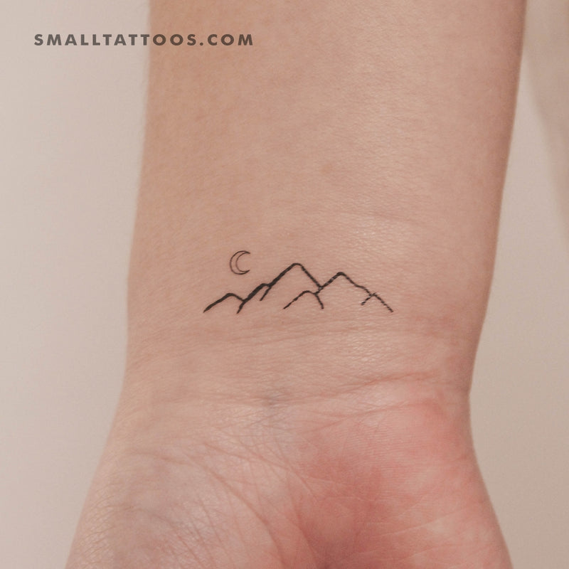 Tiny minimalistic island tattoo located on the wrist.