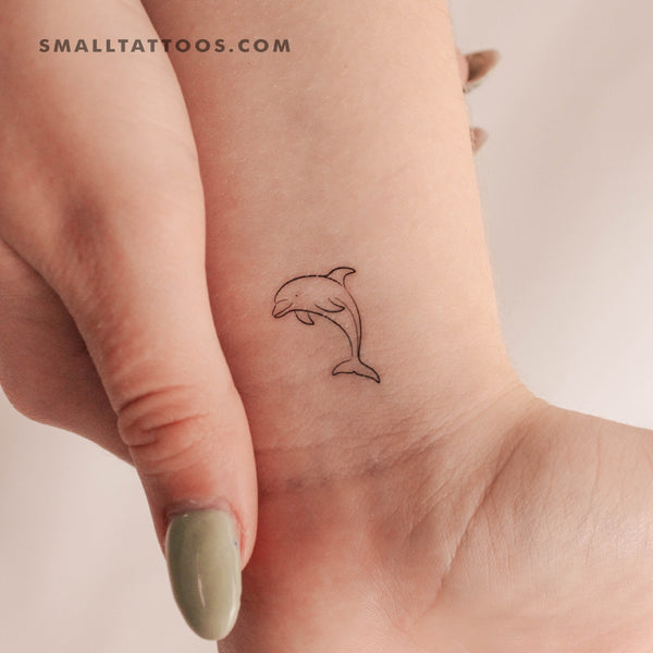 Stick and poke dolphin tattoo by Kate Kalula - Tattoogrid.net