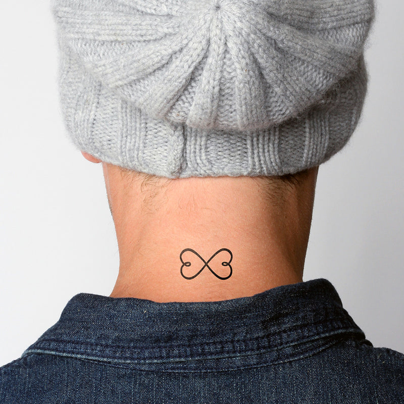Little infinity symbol and flower tattoo located on the