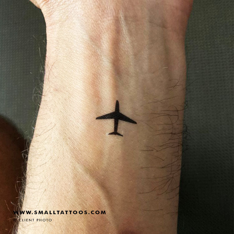 Minimalist airplane and cloud tattoo