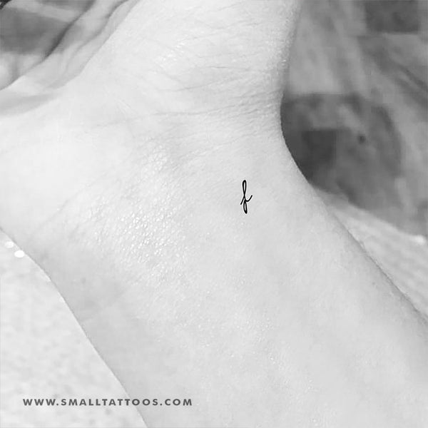 Minimalistic tattoo of the letter F located on the