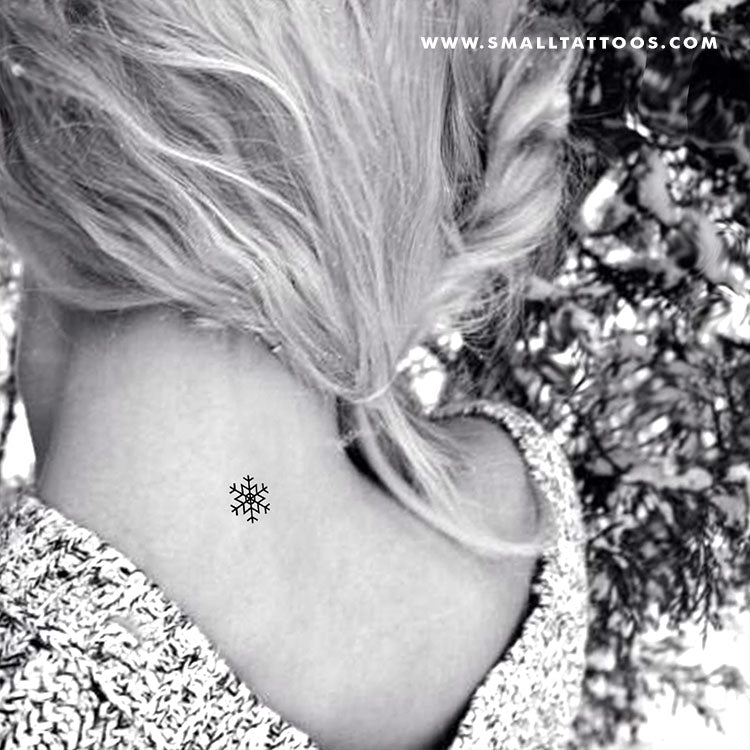 Minimalistic snowflakes tattooed on the wrist.